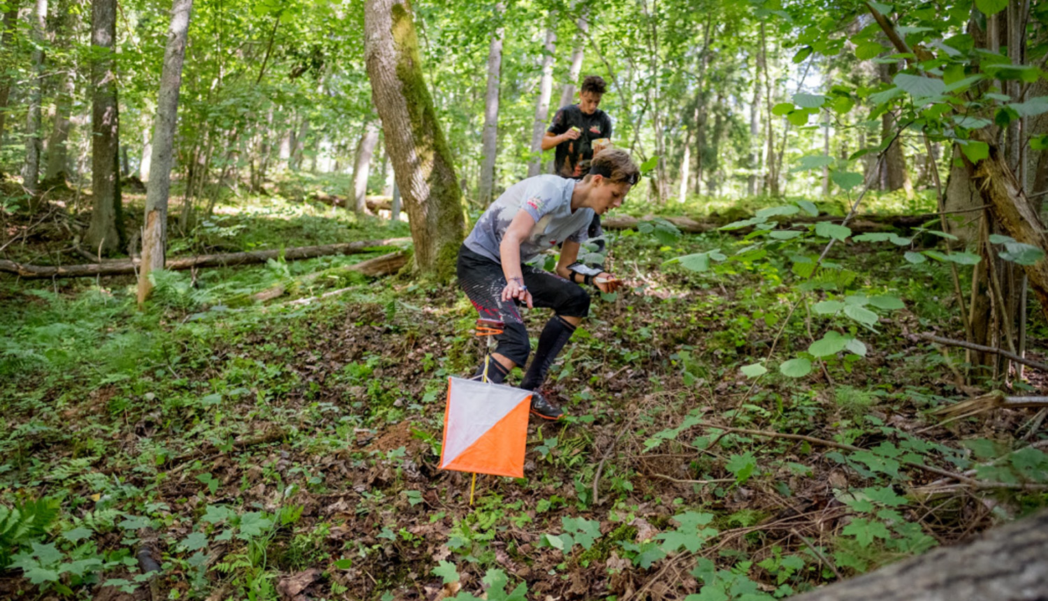 Orientierists mežā pie kontrolpunkta